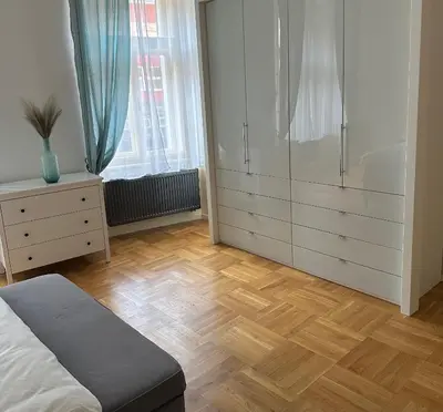 a bedroom with a bed and a dresser and a closet at Byt ve městě Praha 2 in Prague