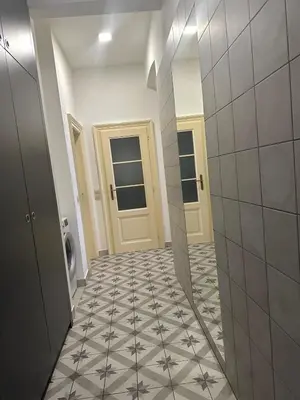 a hallway with a tile floor in a bathroom at Byt ve městě Praha 2 in Prague