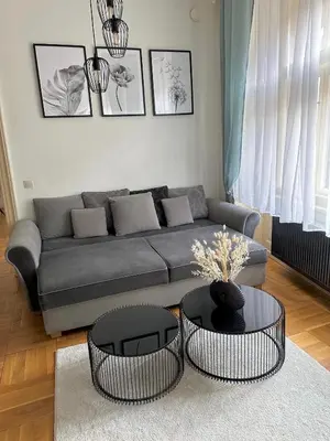 a living room with a couch and two tables at Byt ve městě Praha 2 in Prague