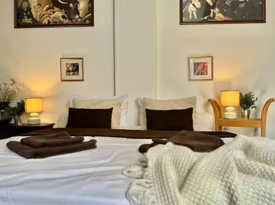 a bedroom with a white bed with towels on it at Old Town Prague Apartment in Prague