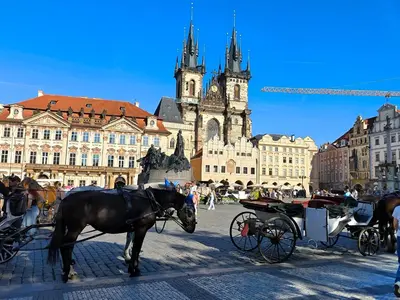 a horse drawn carriage in front of a building at Valentinka Minutes away from Charles Bridge in Prague