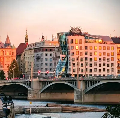 a bridge over a river with buildings at Valentinka Minutes away from Charles Bridge in Prague