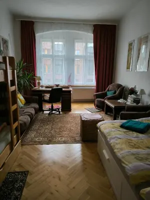 a living room with a couch and a table at Valentinka Minutes away from Charles Bridge in Prague
