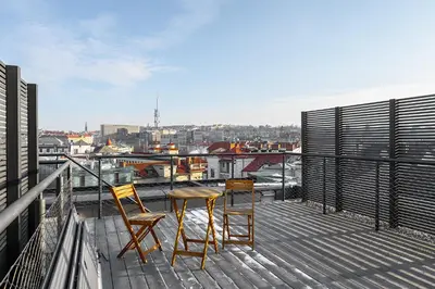 a balcony with two chairs and a table on a building at Luxury apartment in the center in Prague