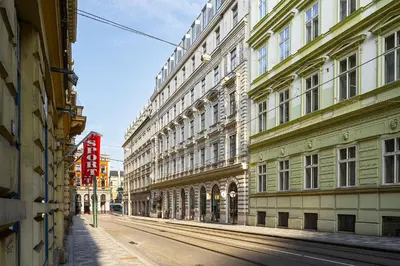 an empty street in a city with tall buildings at Luxury apartment in the center in Prague