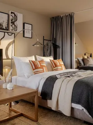 a bedroom with a bed with orange and white pillows at TurnKey I Karlín Square Apartments in Prague