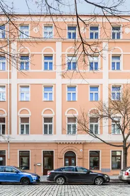 two cars parked in front of a large building at TurnKey I Karlín Square Apartments in Prague