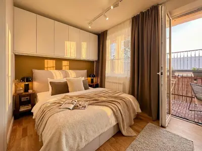 a bedroom with a large bed and a balcony at TurnKey I Karlín Square Apartments in Prague