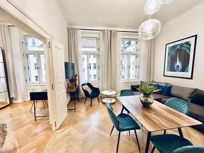 a living room with a couch and a table at River Site Apartment Janáčkovo nábřeží 27 in Prague