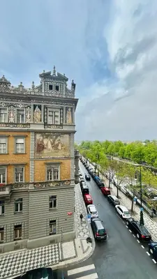 a building with cars parked on the side of a street at River Site Apartment Janáčkovo nábřeží 27 in Prague