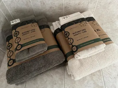 a pile of towels sitting on a bathroom floor at Harrison Homes Prague Apartment 02 Terrace and Parking in Prague