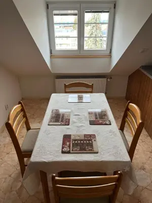 a dining room with a table with chairs and a window at Harrison Homes Prague Apartment 02 Terrace and Parking in Prague