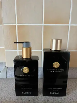 two bottles of perfume sitting on a counter at Harrison Homes Prague Apartment 02 Terrace and Parking in Prague