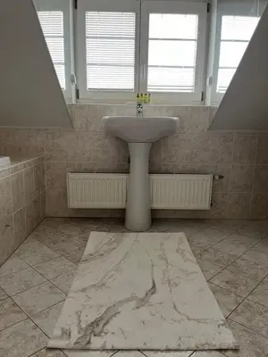 a bathroom with a white sink and a window at Harrison Homes Prague Apartment 02 Terrace and Parking in Prague