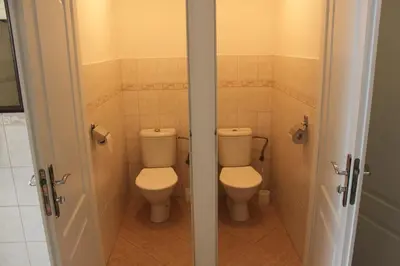 a bathroom with two toilets and two stalls at Pension Trojská in Prague