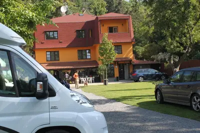 a white van parked in front of a house at Pension Trojská in Prague