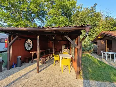 a pergola with a table and chairs on a patio at Pension Trojská in Prague
