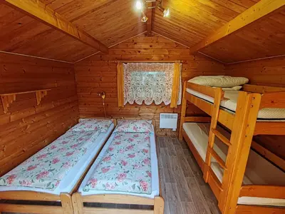 a bedroom with two bunk beds in a cabin at Pension Trojská in Prague
