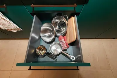 a cabinet with several pots and pans on a shelf at LUX PRAHA in Prague