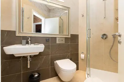 a bathroom with a sink and a toilet and a mirror at LUX PRAHA in Prague