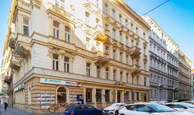 a large building with cars parked in front of it at LUX PRAHA in Prague