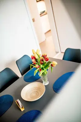 a table with a vase of flowers on it at Fritscher Apartments, s.r.o. in Prague