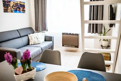 a living room with a table and a couch at Fritscher Apartments, s.r.o. in Prague