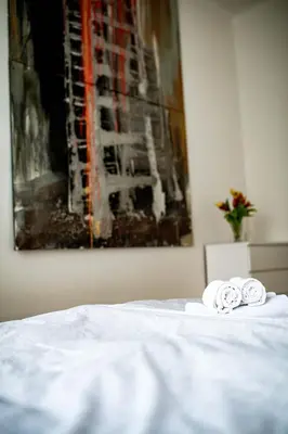 two rolled towels sitting on top of a bed at Fritscher Apartments, s.r.o. in Prague