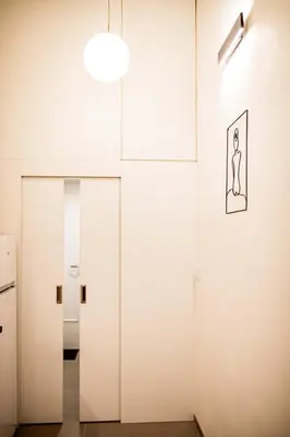 a room with white walls and a door with a picture on the wall at Fritscher Apartments, s.r.o. in Prague