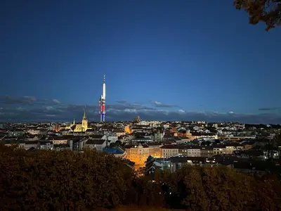 a view of a city at night with a tower at Cozy Garden Apartment in the heart of Prague in Prague