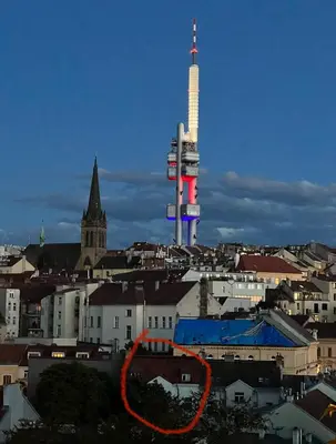 a view of a city with a tower in the background at Cozy Garden Apartment in the heart of Prague in Prague