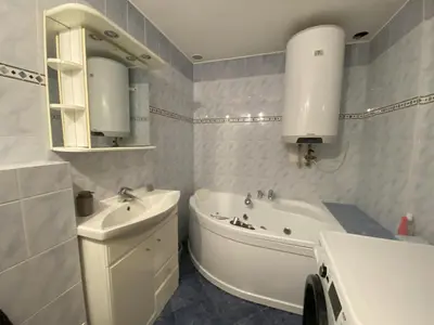 a bathroom with a sink and a tub and a toilet and a sink at Cozy Garden Apartment in the heart of Prague in Prague