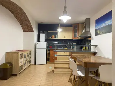 a kitchen with a table and a white refrigerator at Cozy Garden Apartment in the heart of Prague in Prague