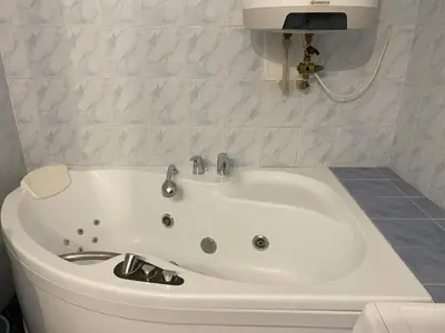 a white bath tub in a bathroom with a sink at Cozy Garden Apartment in the heart of Prague in Prague