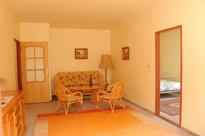 a living room with a couch and a table and chairs at Penzion Flídr in Poděbrady