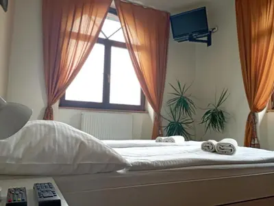 a bedroom with a bed with two towels on it at Penzion Flídr in Poděbrady