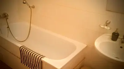 a bathroom with a bath tub and a sink at Penzion Flídr in Poděbrady