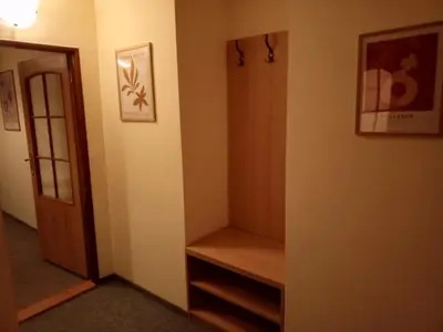 a hallway with a door and a shelf in a room at Penzion Flídr in Poděbrady