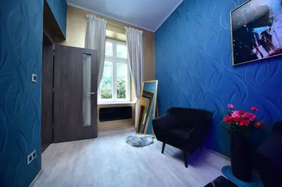 a hallway with a vase of flowers on the floor at Vltava Design Apartments in Prague