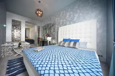 a bedroom with a large bed with a tv on the wall at Vltava Design Apartments in Prague