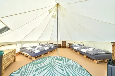 a marquee with two beds in a tent at Glamping Slapy in Slapy