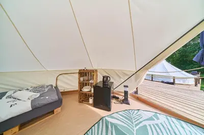 a tent with a bed and a tv in a room at Glamping Slapy in Slapy