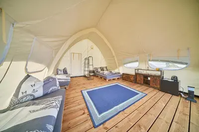 a tent with a swimming pool inside of it at Glamping Slapy in Slapy