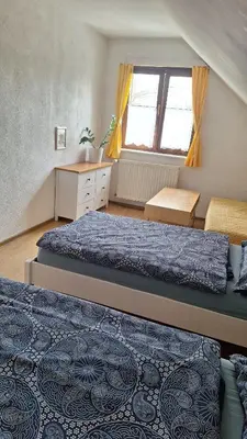 a bathroom with a white toilet and a sink at Pension Egida in Řež