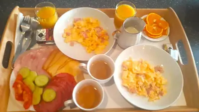 a tray with plates of breakfast food on a table at LEV I SOVA in Mělník