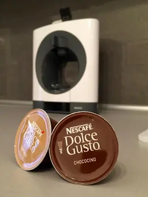 a container of chocolate next to a coffee maker at Beautiful Apartments in Prague in Prague