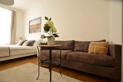 a living room with a couch and a table at Beautiful Apartments in Prague in Prague
