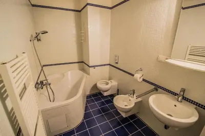 a bathroom with a tub and a toilet and a sink at National Theater Ruterra Flat in Prague