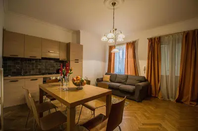 a kitchen and living room with a table and a couch at National Theater Ruterra Flat in Prague