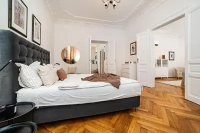 a bedroom with a large bed with a black headboard at Luxurious two-bedroom in the Old Town in Prague